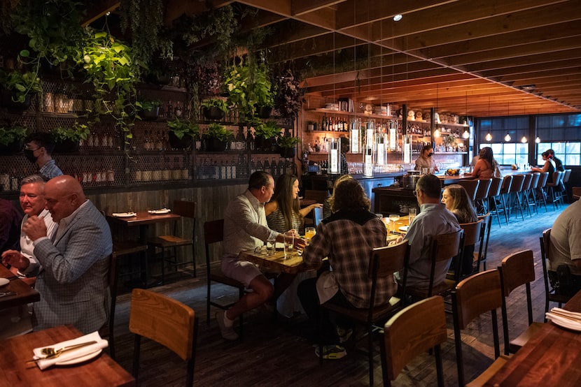 The dining area at Rye has brick on one side, a living plant wall on another.