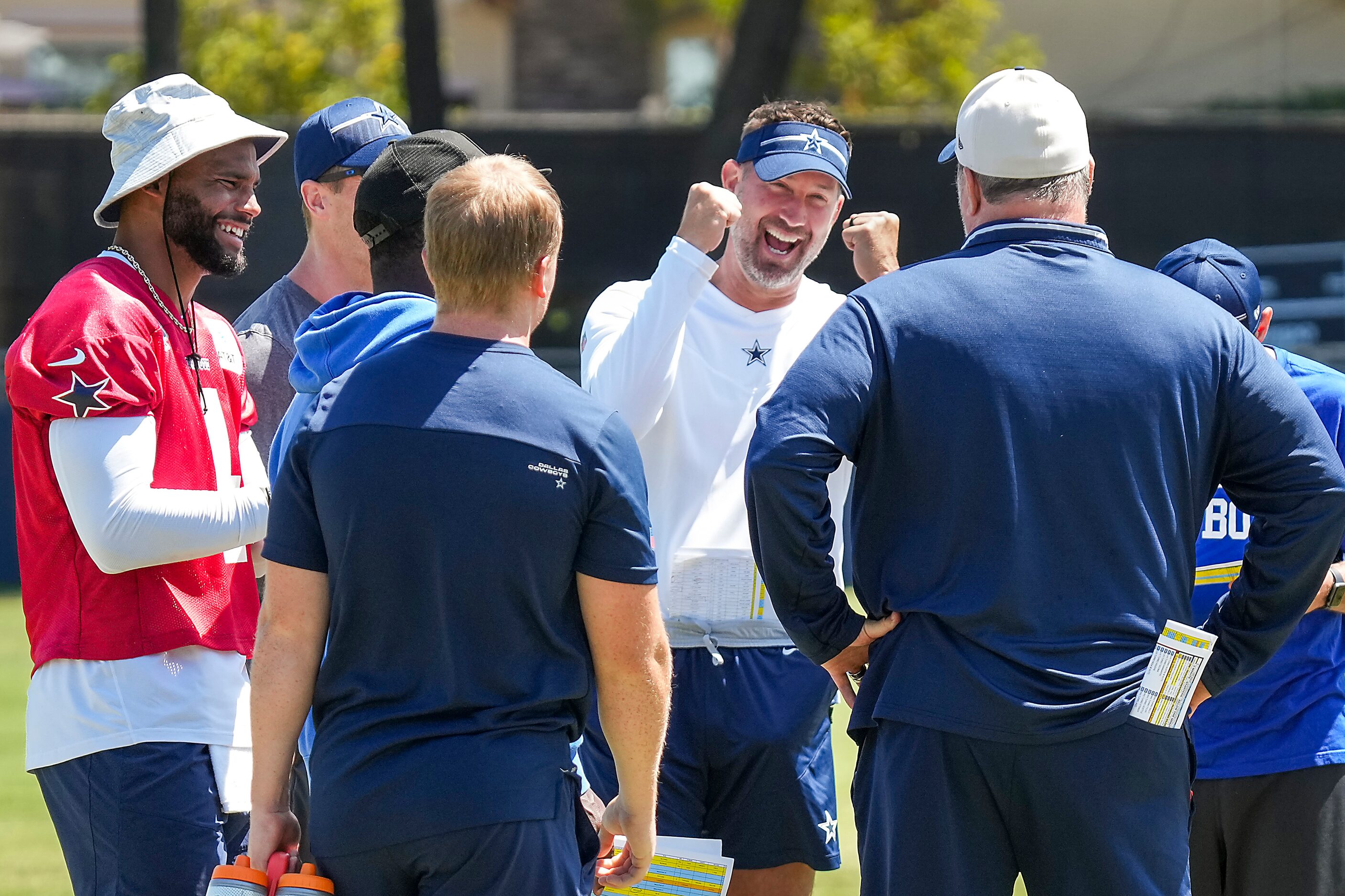 Dallas Cowboys offensive coordinator Brian Shottenheimer laughs with head coach Mike...