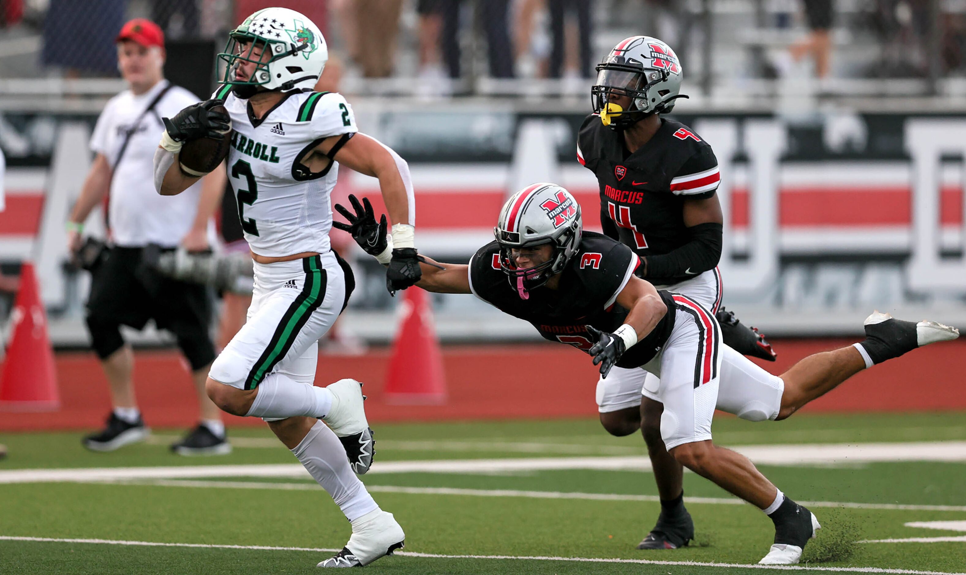 Southlake Carroll running back Owen Allen (2) races past Flower Mound Marcus defensive back...