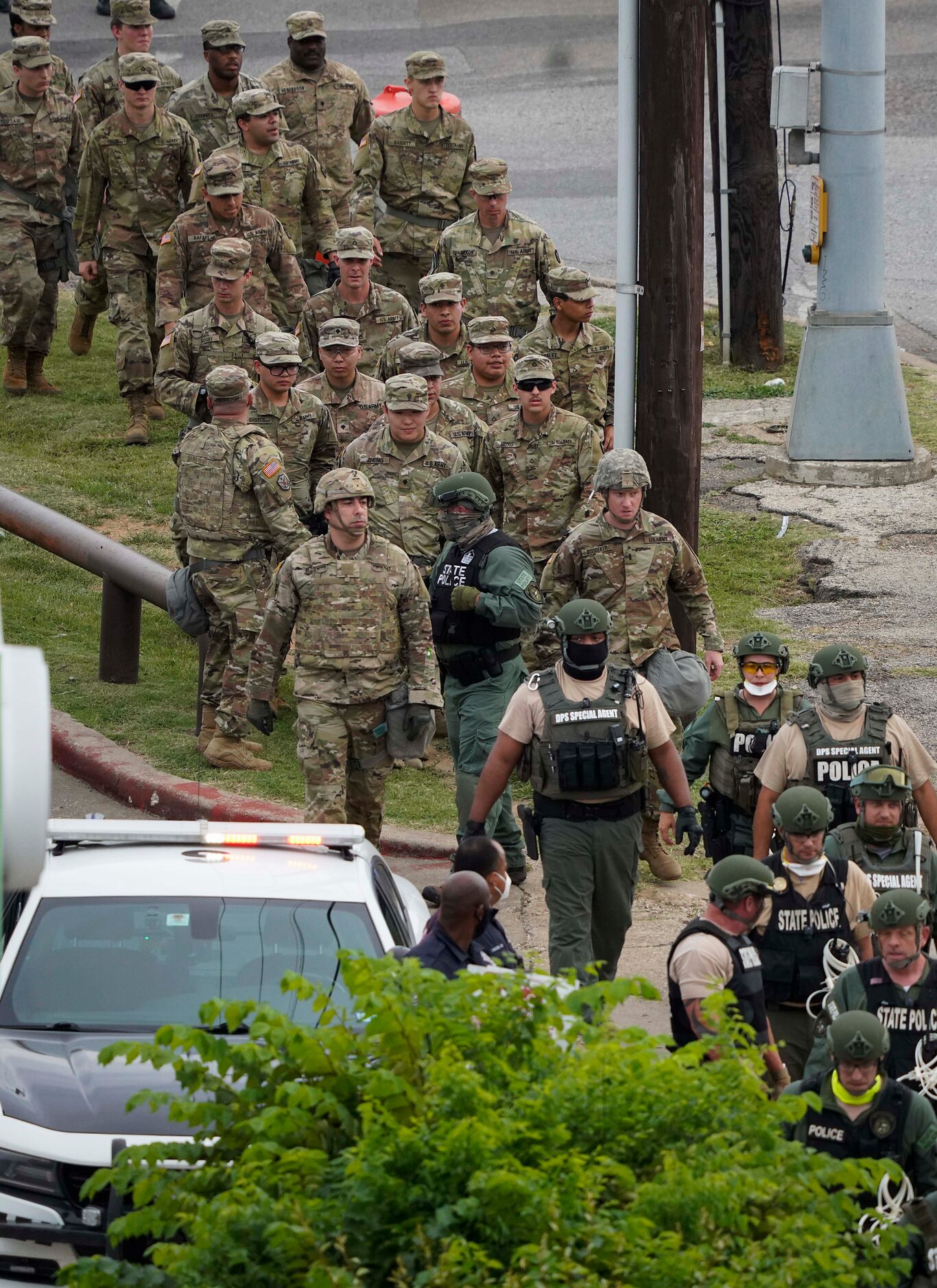 National Guard troops and DPS troopers head toward a protest rally the Frank Crowley Courts...