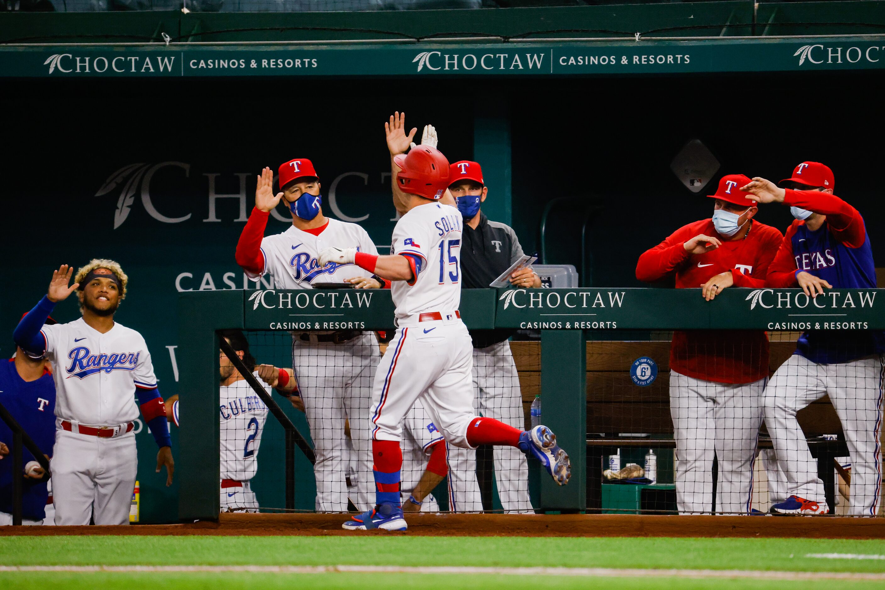 Texas Rangers second baseman Nick Solak (15) runs to the dugout after hitting a homer on a...