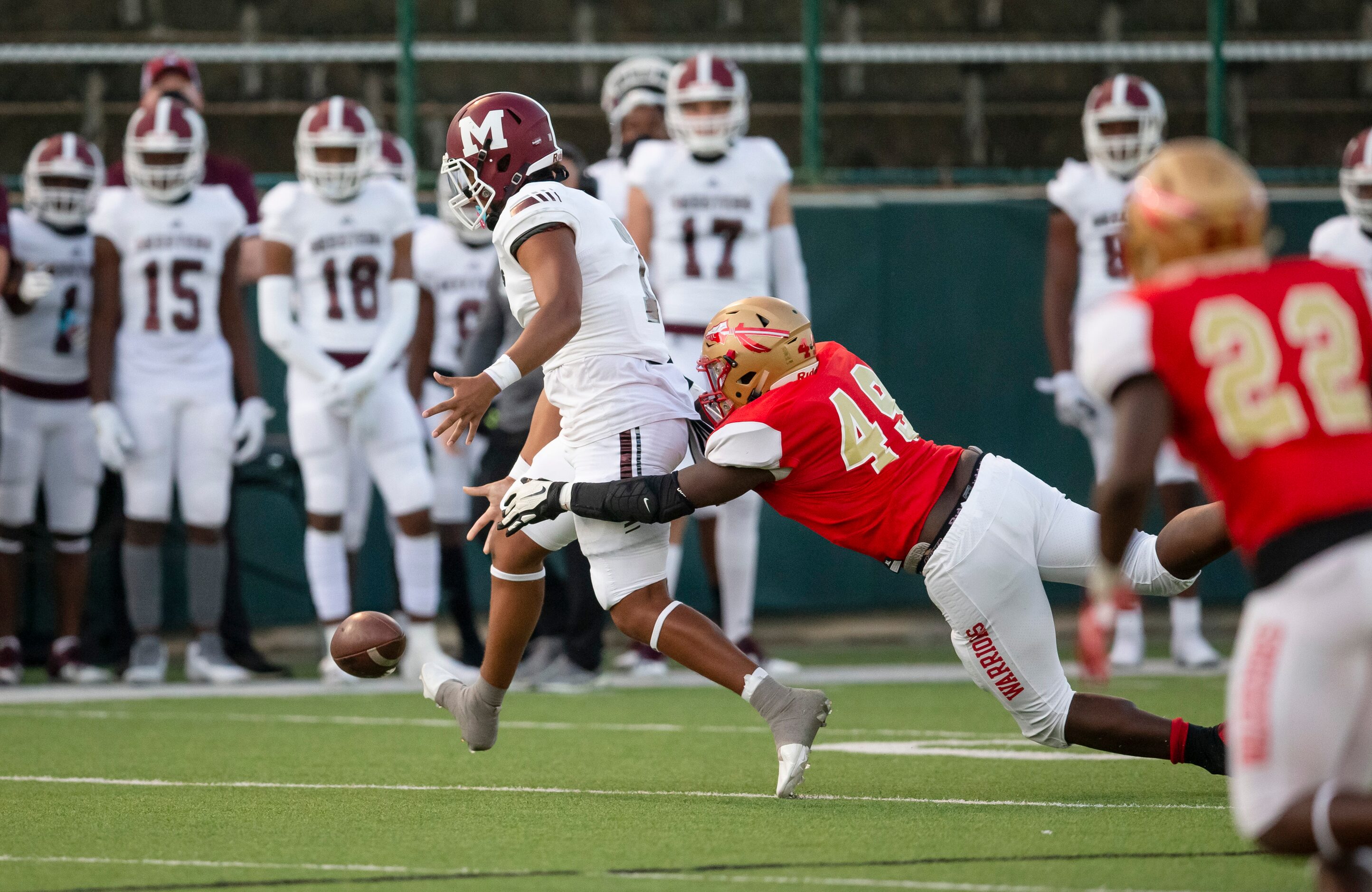 South Grand Prairie junior defensive end Silvano Bent (49) forces Mesquite junior...