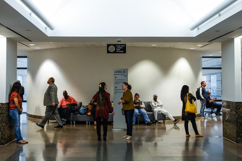 People waited and walked in the hallways of the Frank Crowley Courts Building on Monday,...