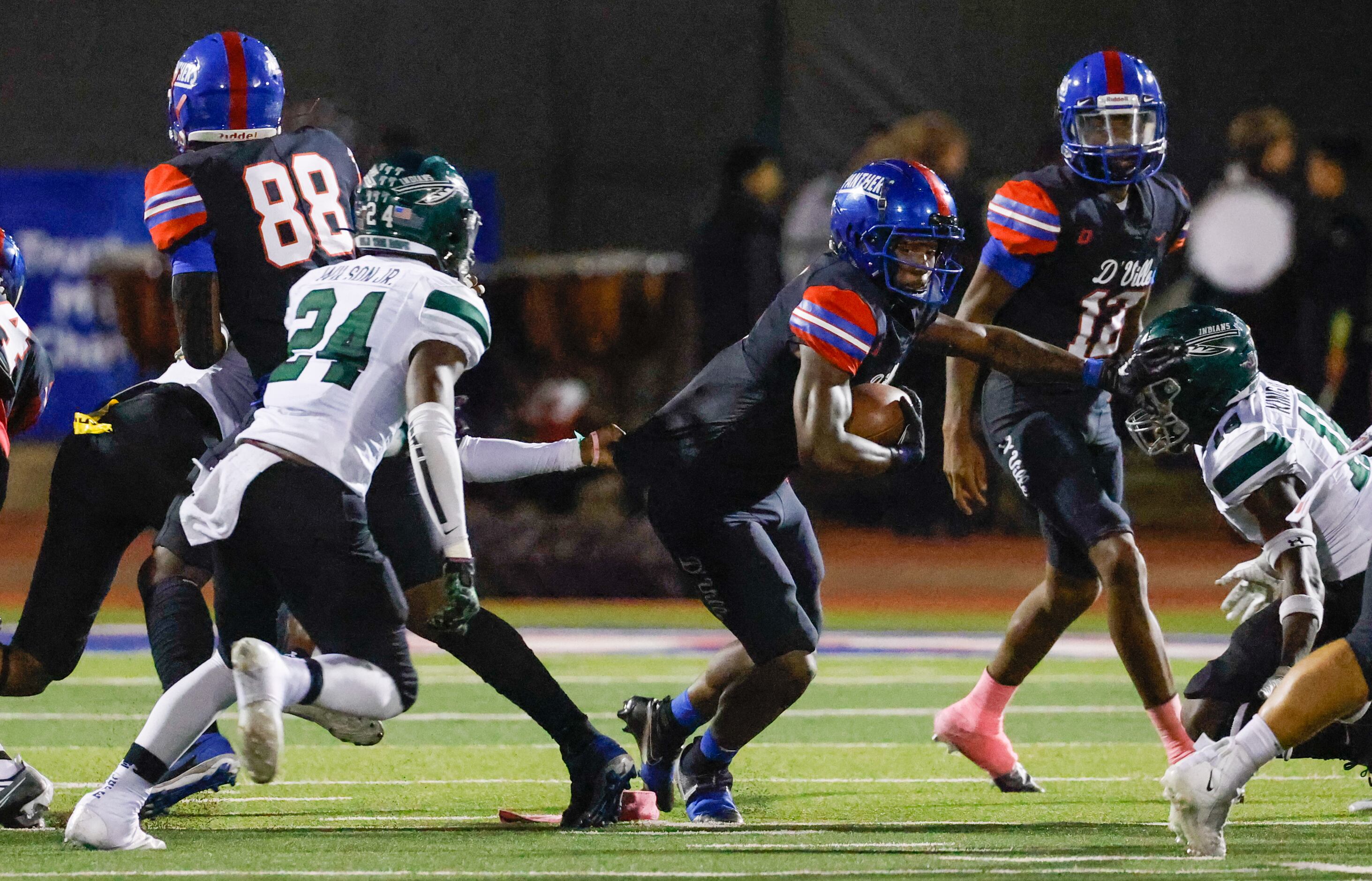 Duncanville running back Kaleb Kenney (9) pushes against a Waxahachie defender as another...