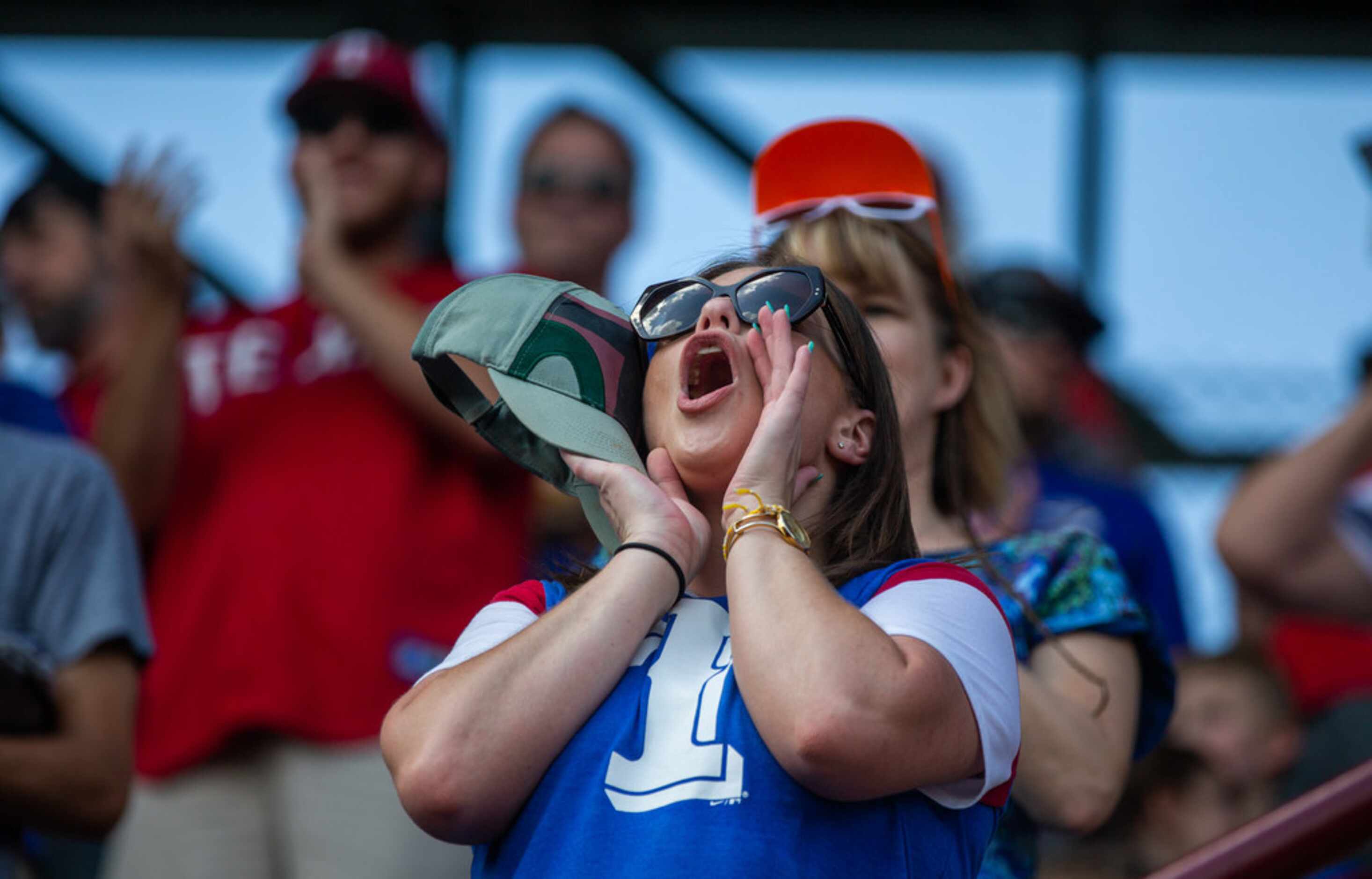 Savannah Henson, from Justin, Texas, cheers during the opening of the Texas Rangers' final...