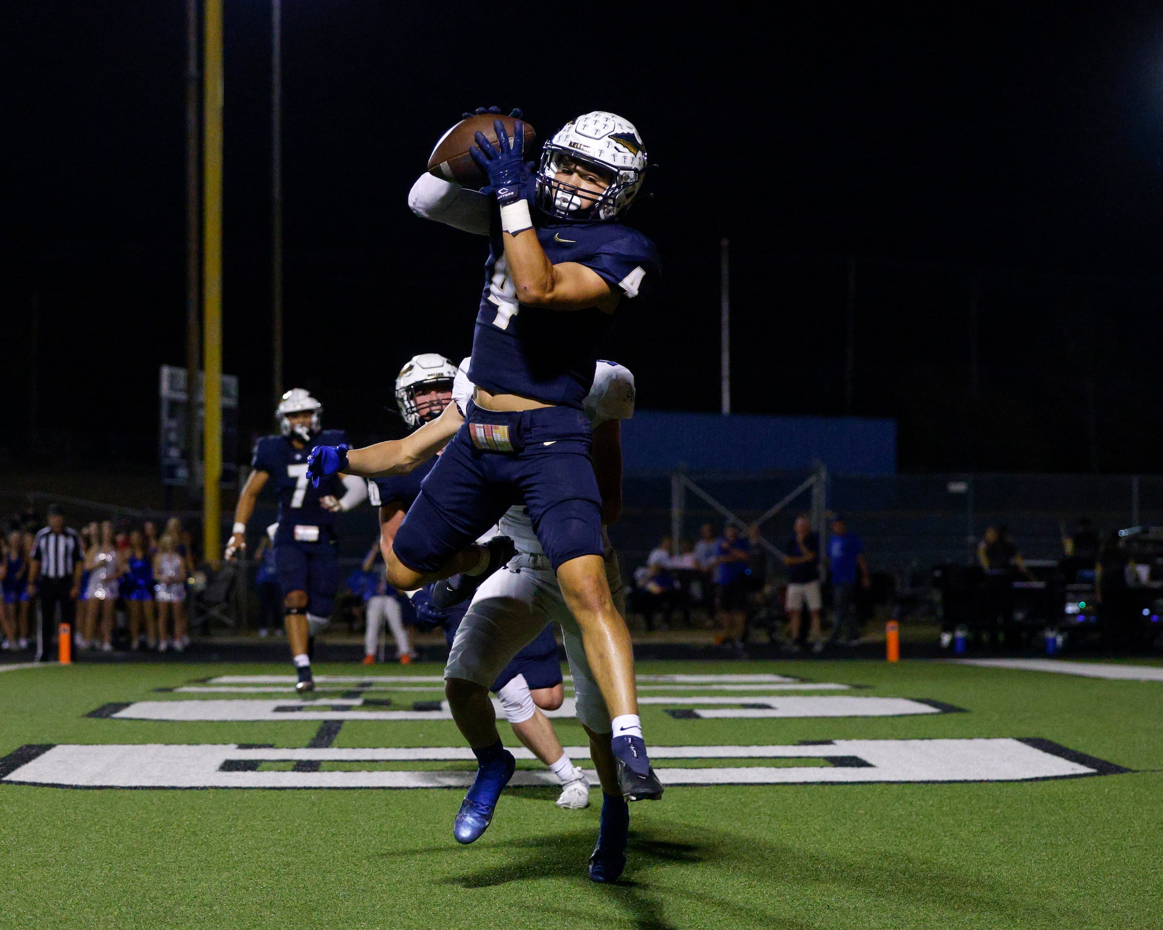 Keller defensive back Eli Brinton (4) intercepts a pass during the first half of a game...