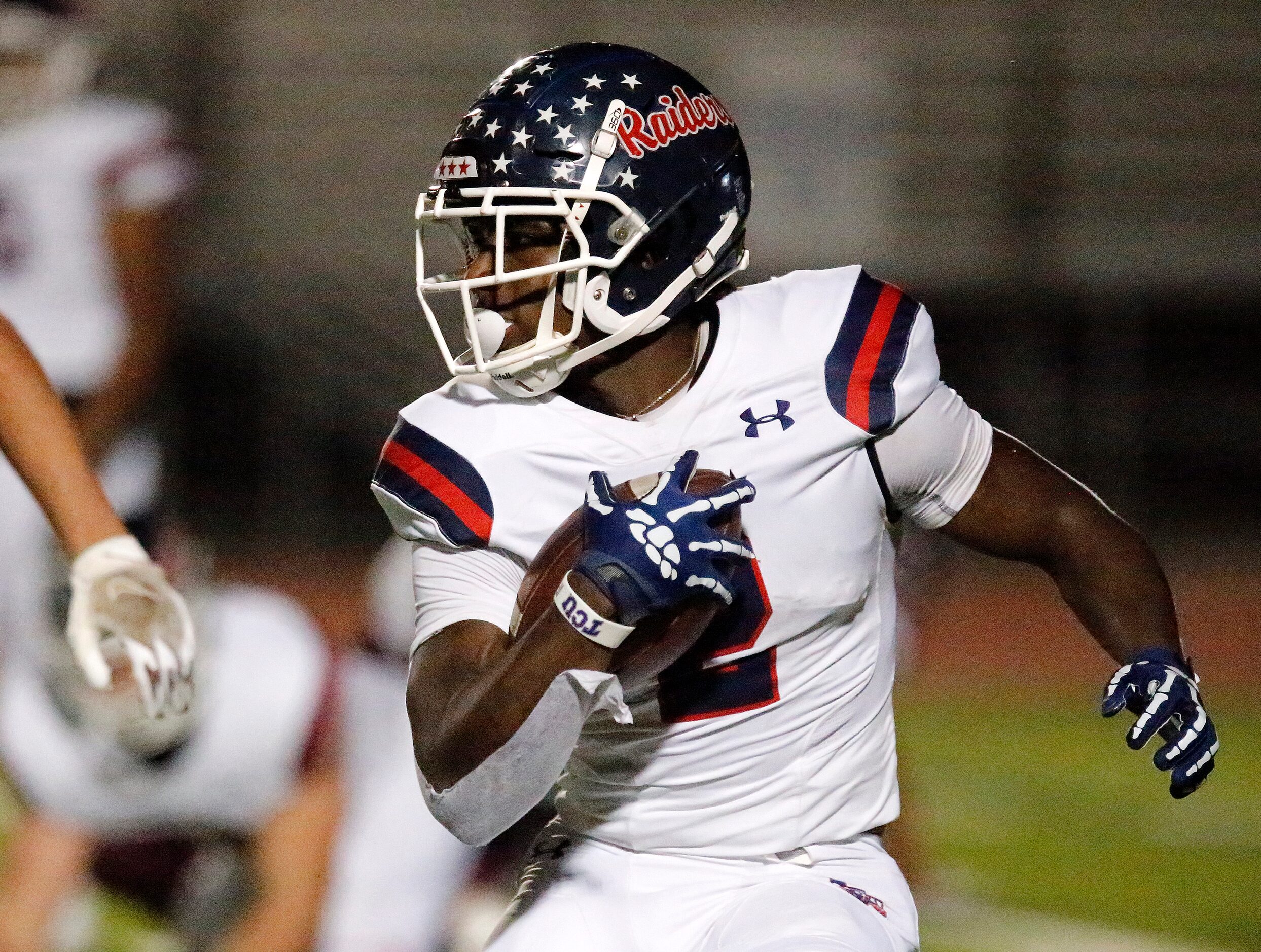 Denton Ryan High School running back Kalib Hicks (2) gets a big gain during the first half...