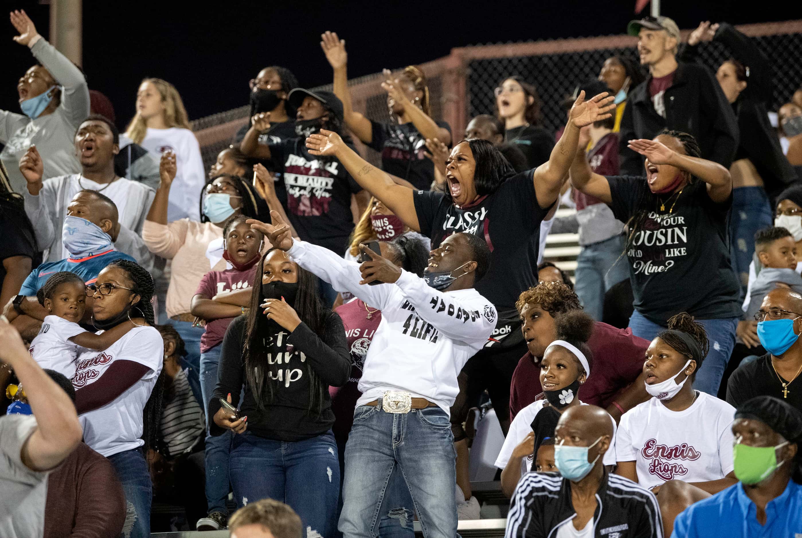 Ennis fans react to a Red Oak touchdown during the second half of a high school football...