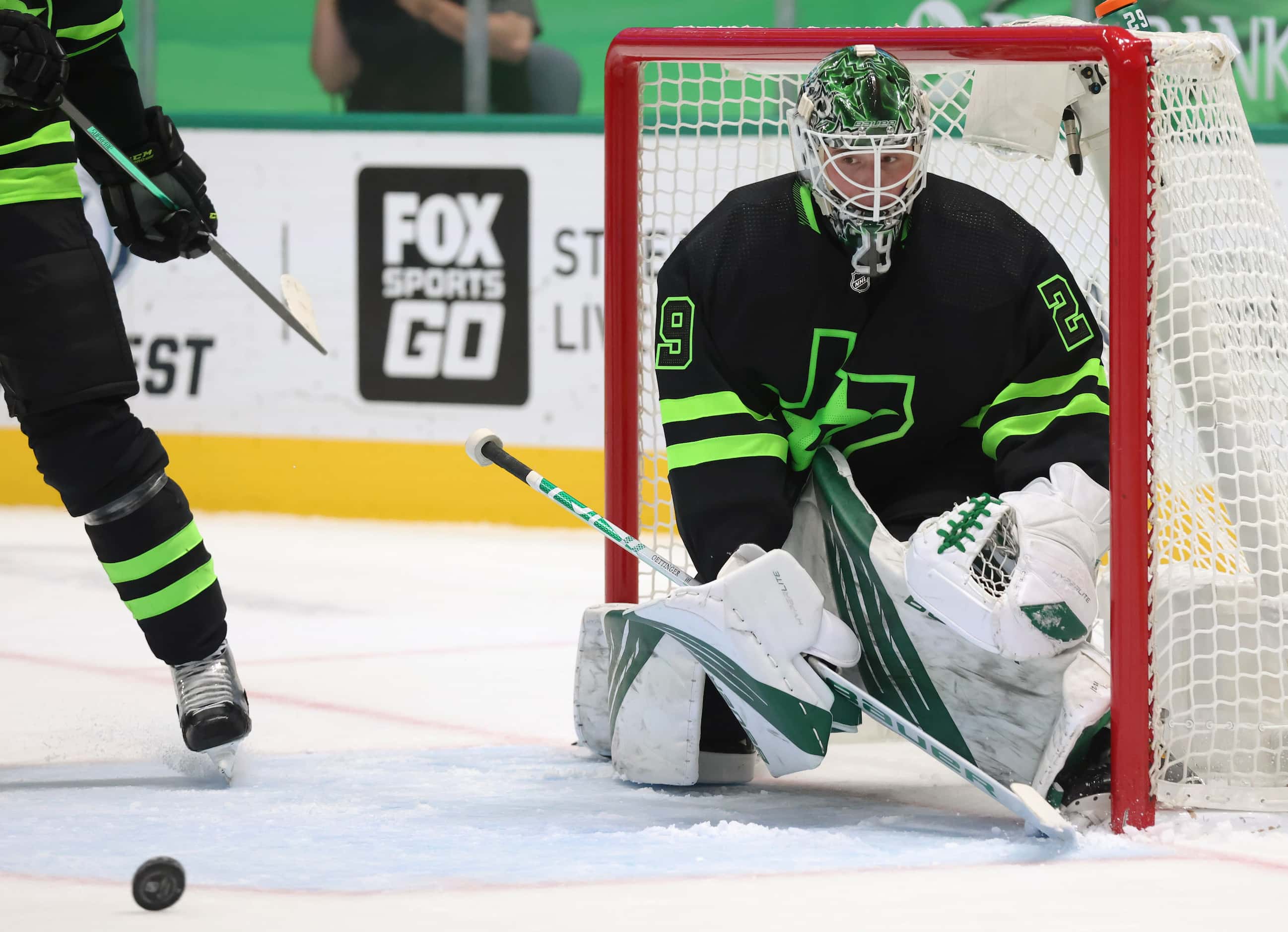 Dallas Stars goaltender Jake Oettinger (29) watches as the puck rolls in a game against the...