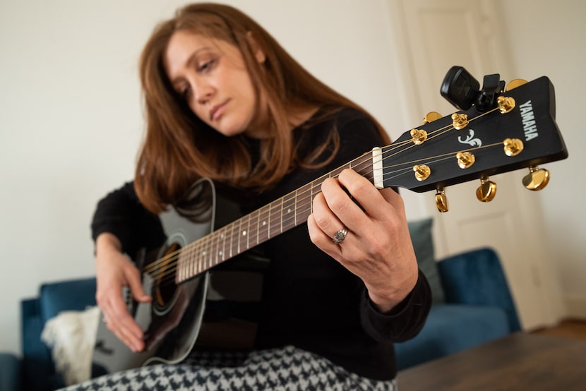 Augustine Frizzell with her guitar inside her office at her home in Dallas  on Jan. 11,...