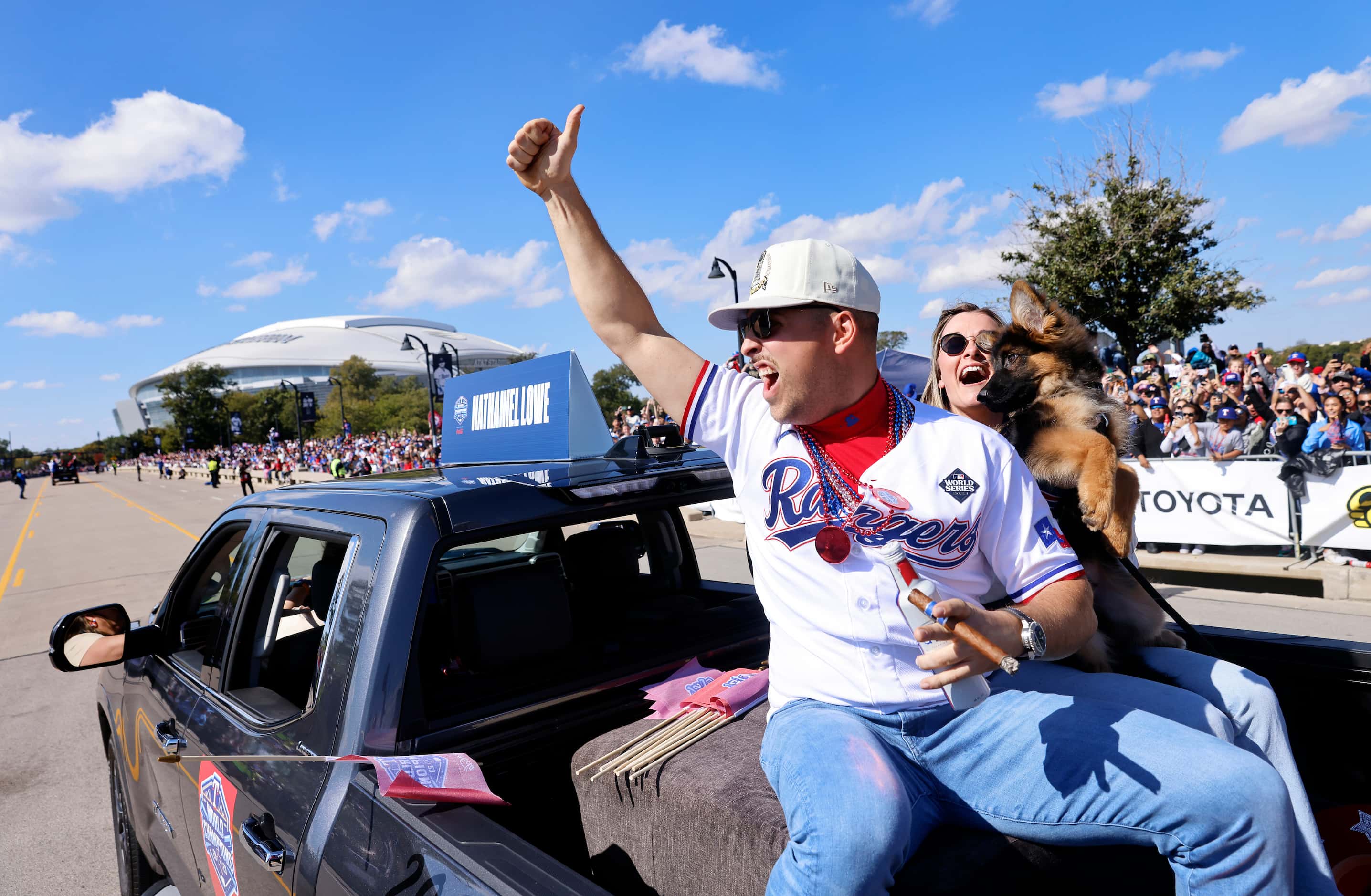 Texas Rangers first baseman Nathaniel Lowe celebrates with fans during the World Series...