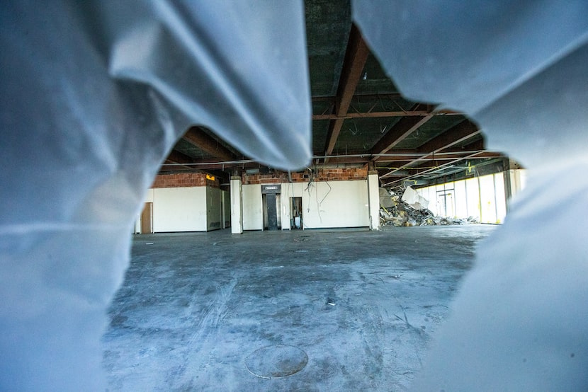 As seen through a broken window, the former Salvation Army Dallas headquarters sits vacant...