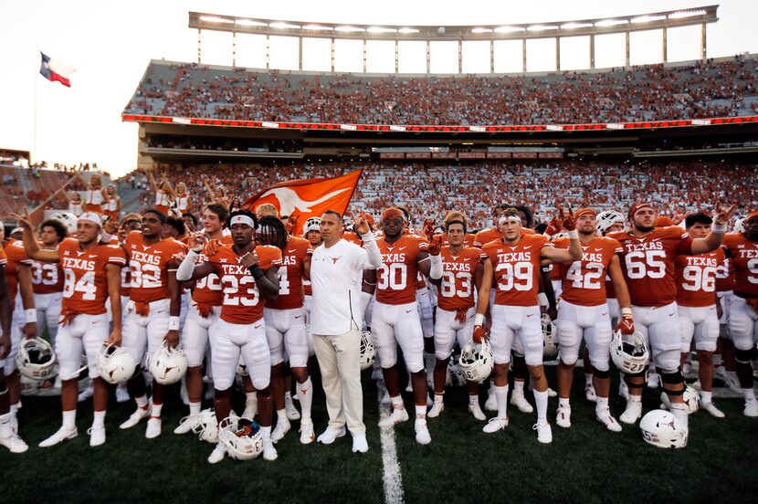 Texas Longhorns head coach Steve Sarkisian (center) and his players sing 'The Eyes of Texas'...