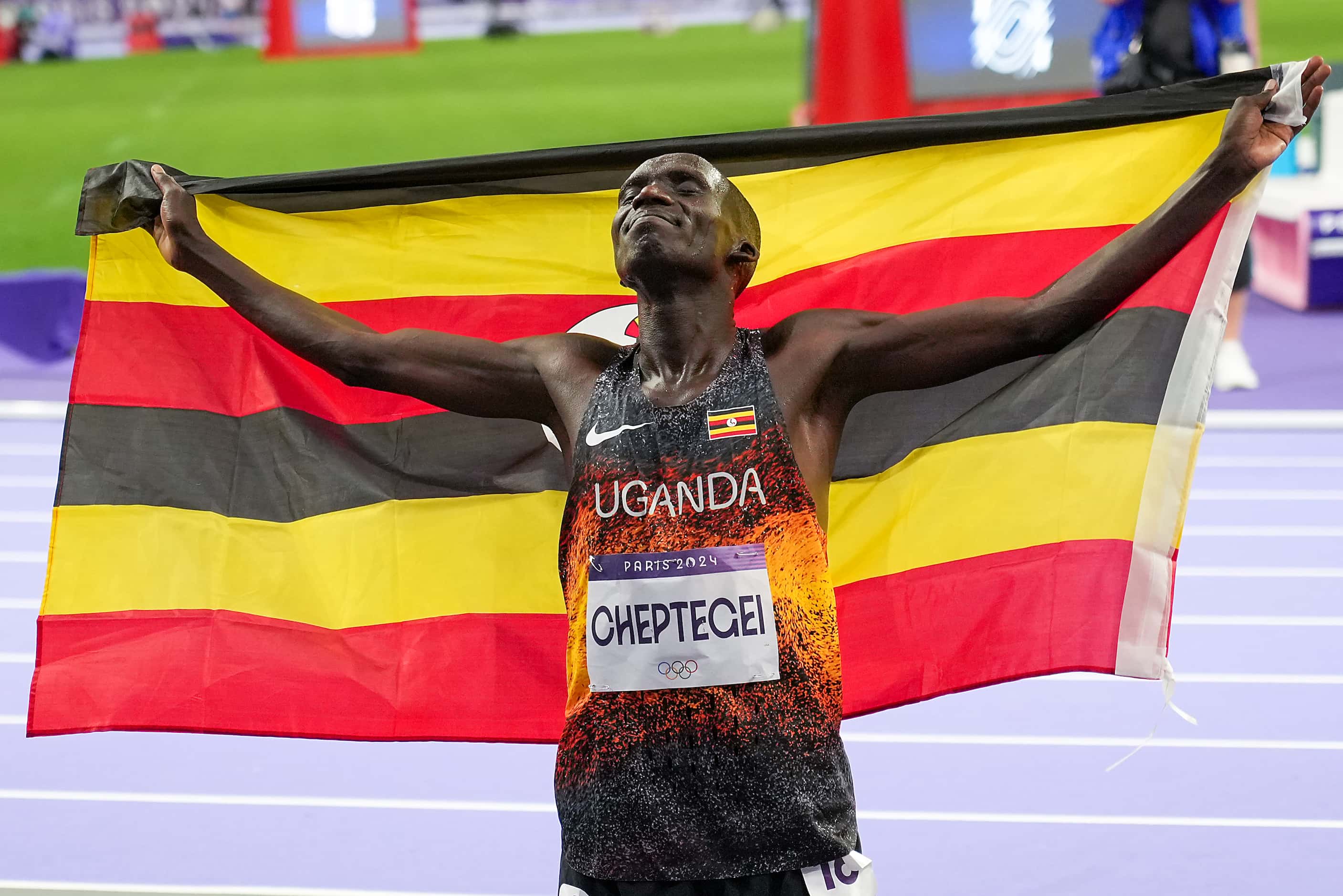 Joshua Cheptegei of Uganda celebrates after winning the men’s 10,000-meters at the 2024...