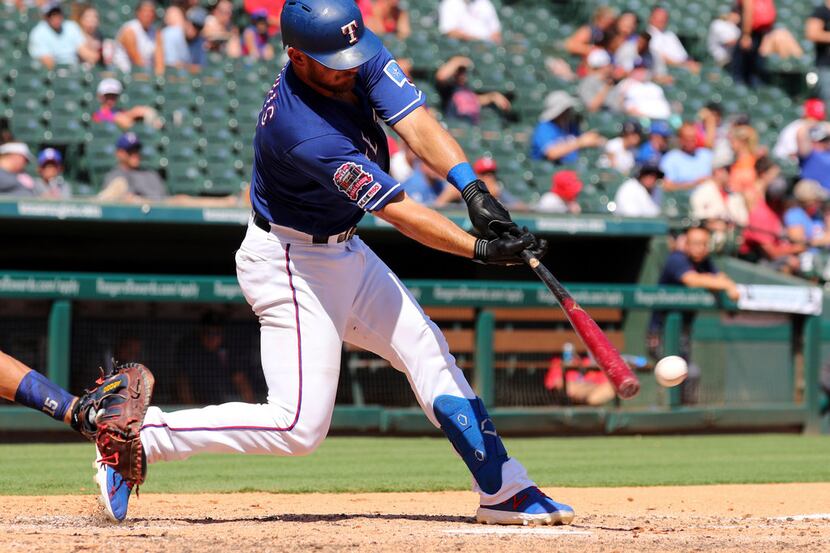Texas Rangers' Jeff Mathis hits a two-run single in the third inning of a baseball game...
