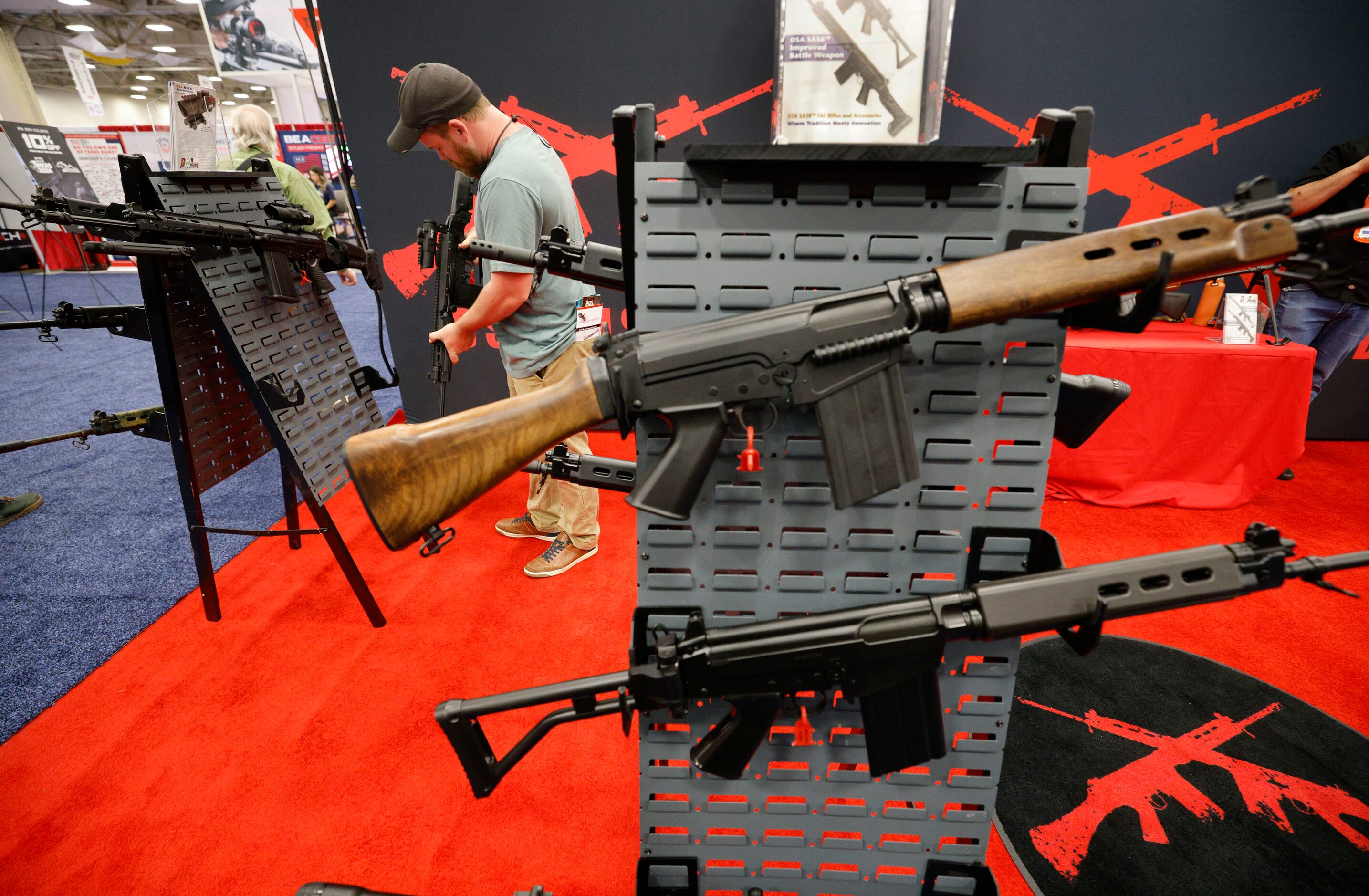 Daniel Lewis of Plano checks products at the DS Arms booth during 2024 NRA Annual Meetings &...