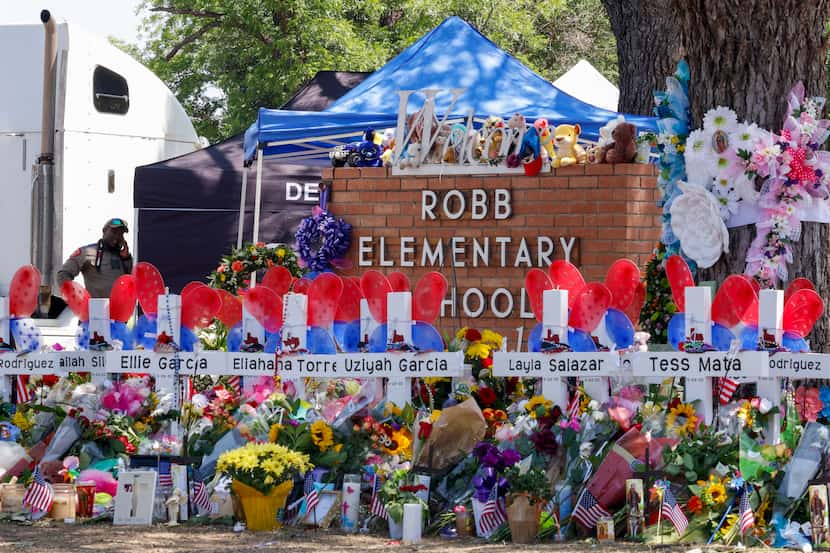 Crosses bear the names of the victims of the Robb Elementary School shooting in Uvalde,...