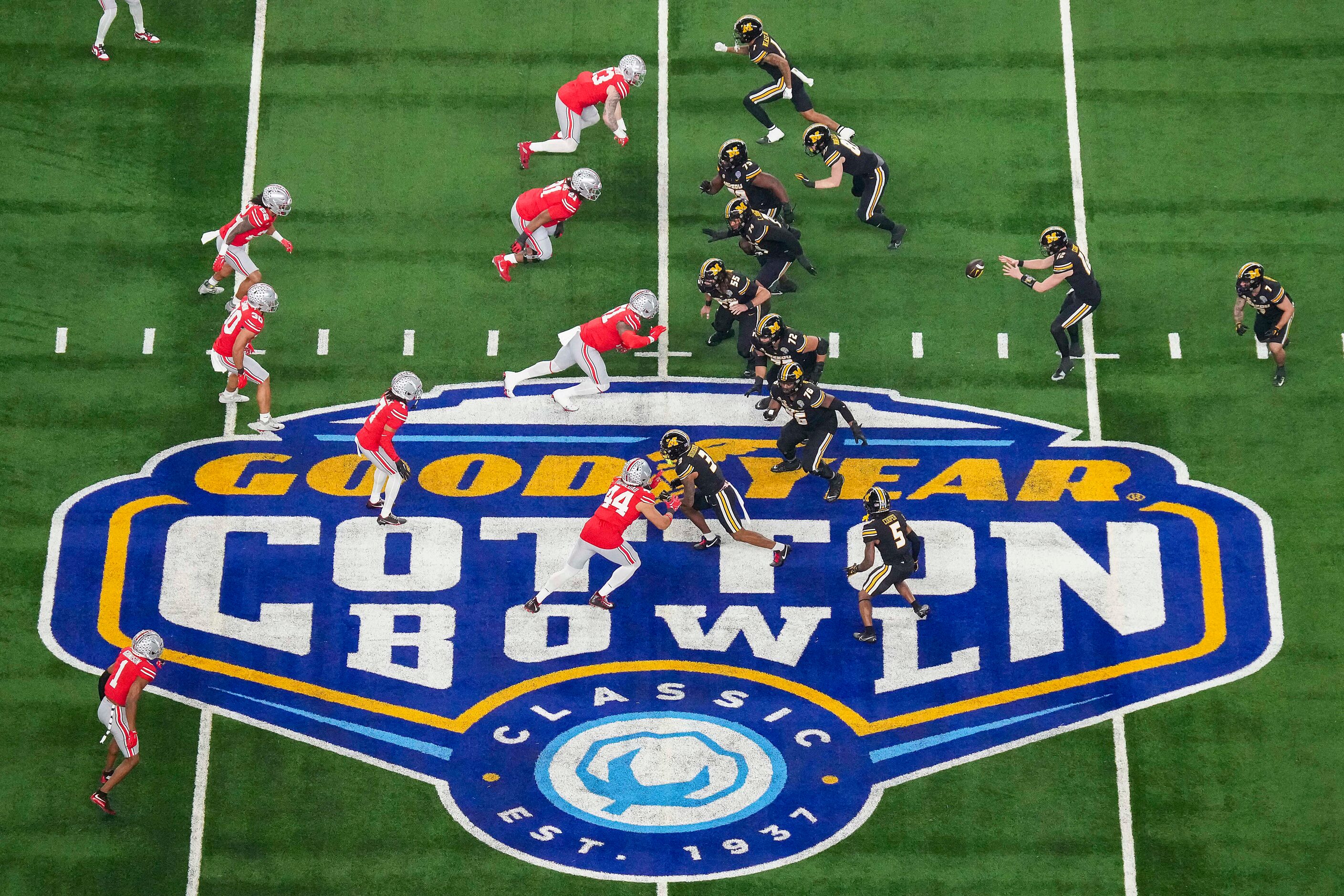 Missouri quarterback Brady Cook (12) takes a snap at midfield during the first half of the...