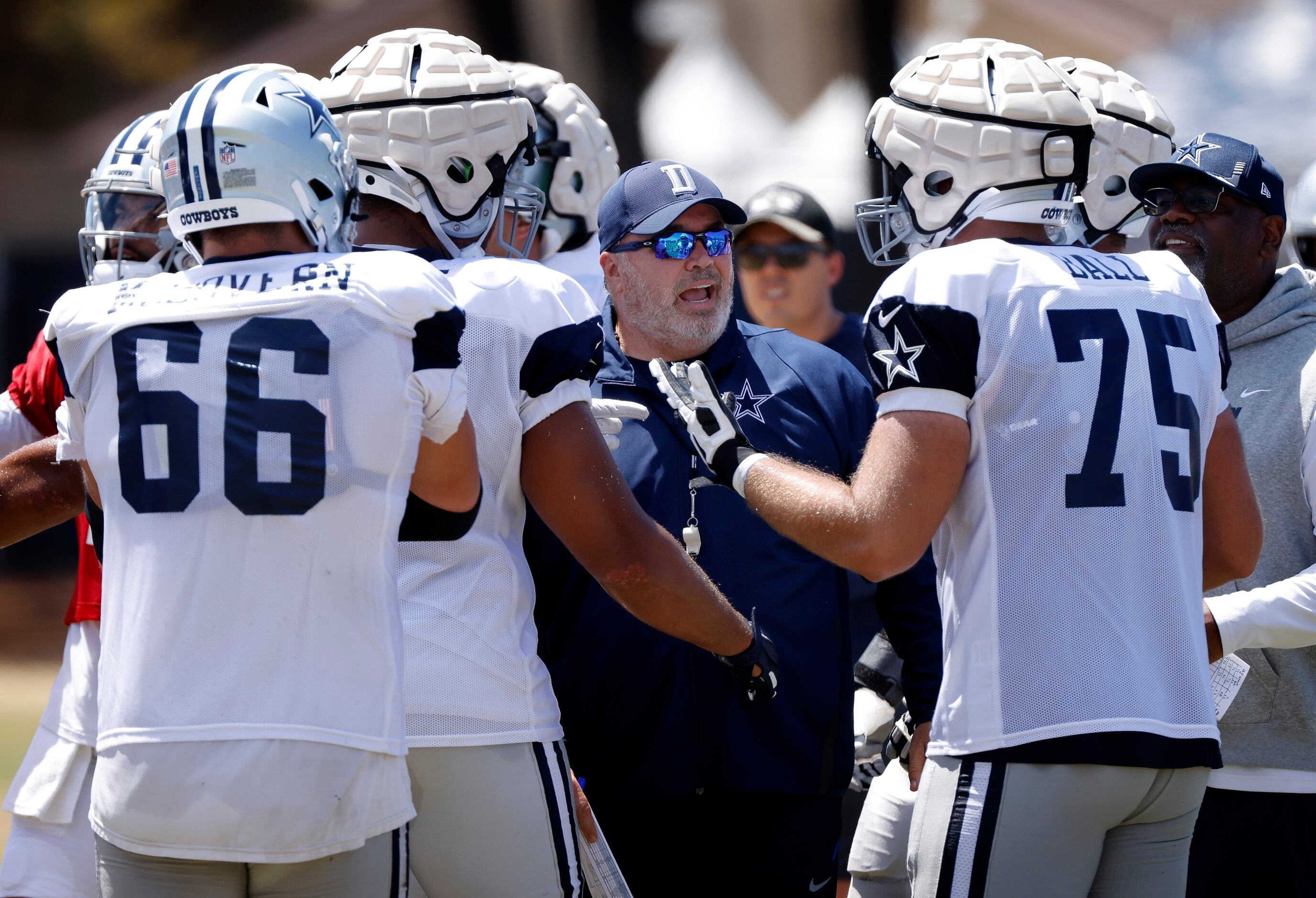 Dallas Cowboys head coach Mike McCarthy steps in and settles his offensive players who were...