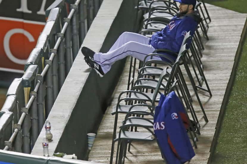 Texas pitcher Nick Martinez sits alone in the bullpen during the Oakland Athletics vs. the...