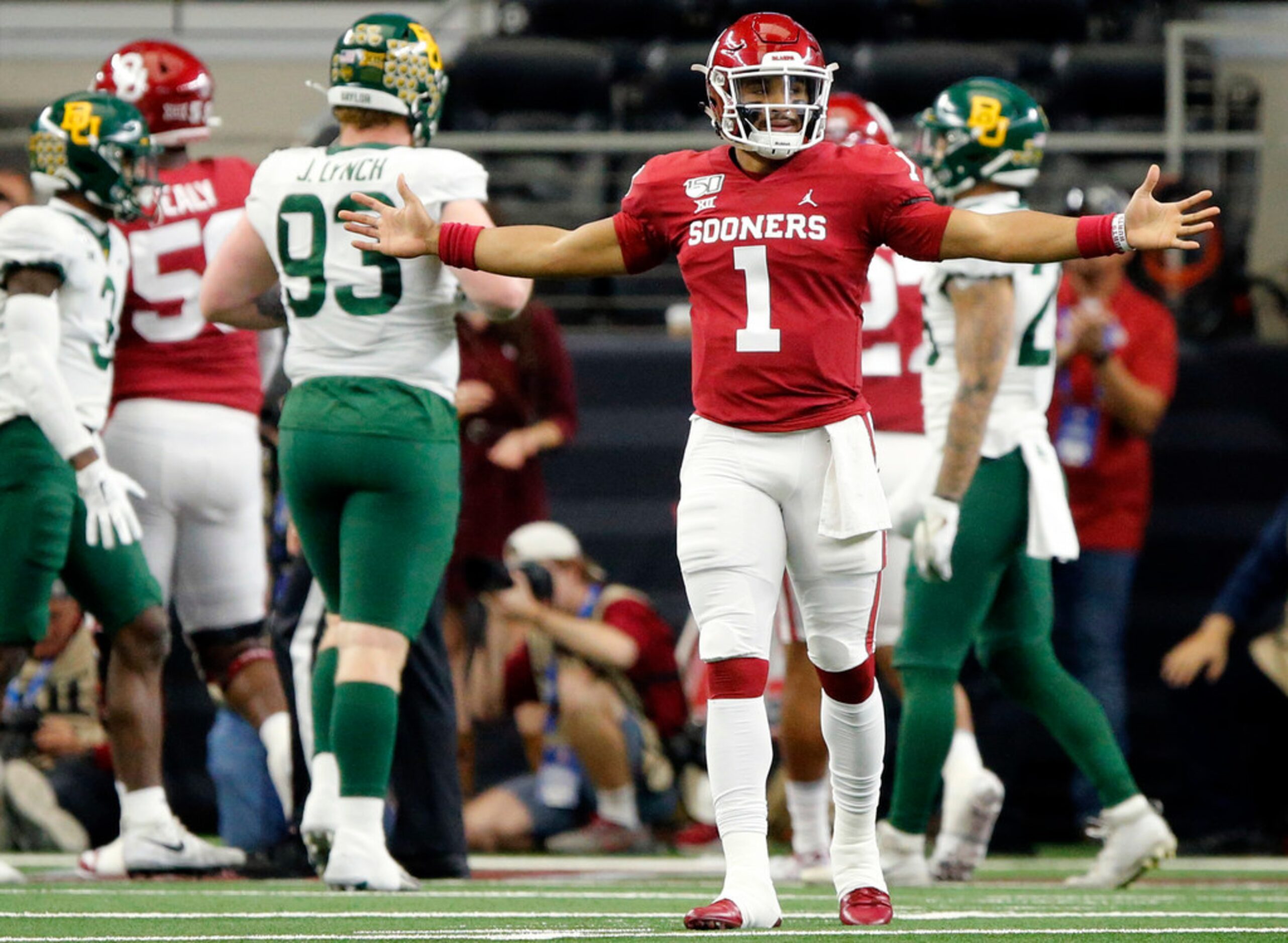 Oklahoma Sooners quarterback Jalen Hurts (1) celebrates running back Kennedy Brooks's first...