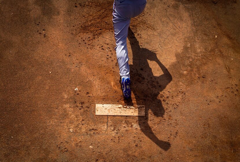 Rangers pitcher Joe Palumbo warmed up in the bullpen before a spring training game against...