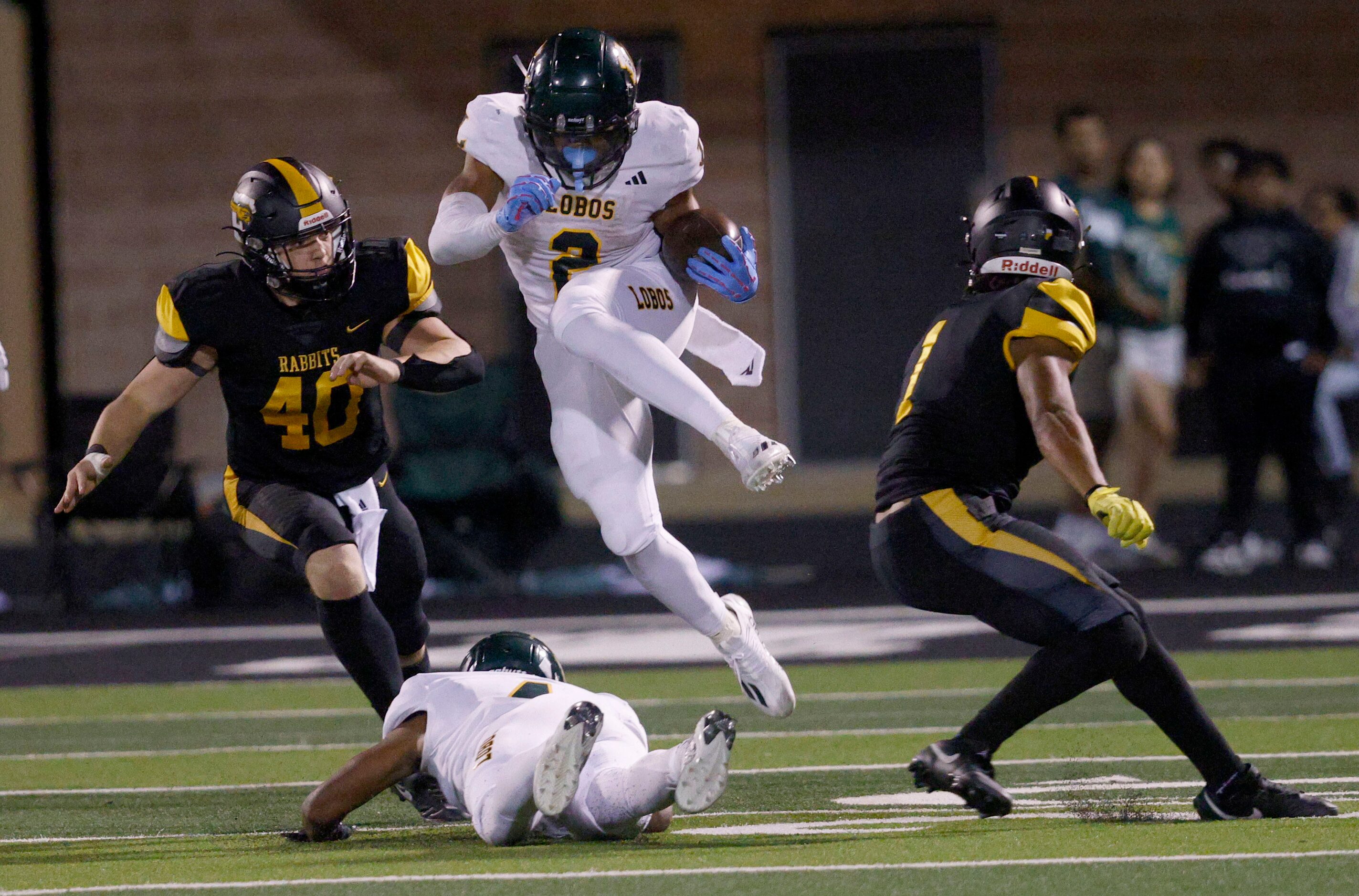 Longview's Taylor Tatum (2) jumps over Longview's Buster Mumphrey (4) as Forney's Landry...