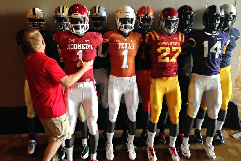 Sean Hollister puts up the final mannequin as event staff break down the 2015 Big 12...