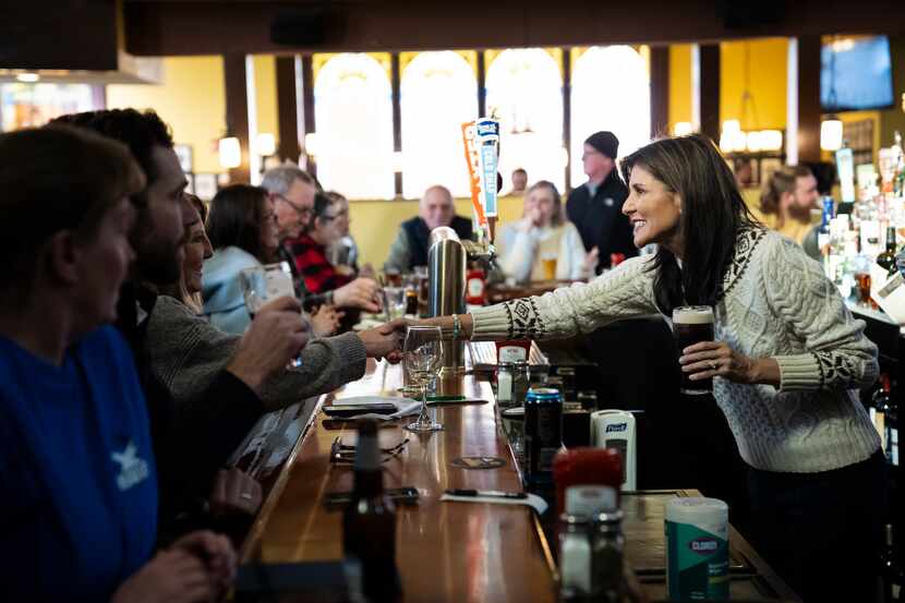 Republican presidential candidate  Nikki Haley, right, meets with diners at the Holy Grail...