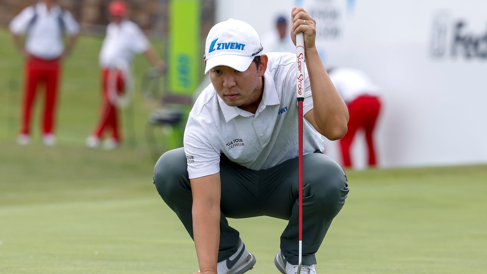 S.Y. Noh, of South Korea, lines up a birdie putt on the 18th green during the first round of...