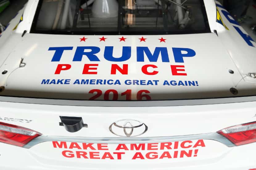The presidential Donald Trump themed Sprint Cup series car sits on the blocks as crewman for...