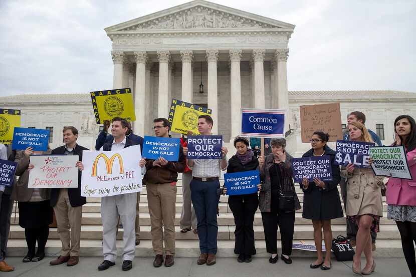Protesters rally outside the Supreme Court in Washington, April 2, 2014. The Supreme Court...