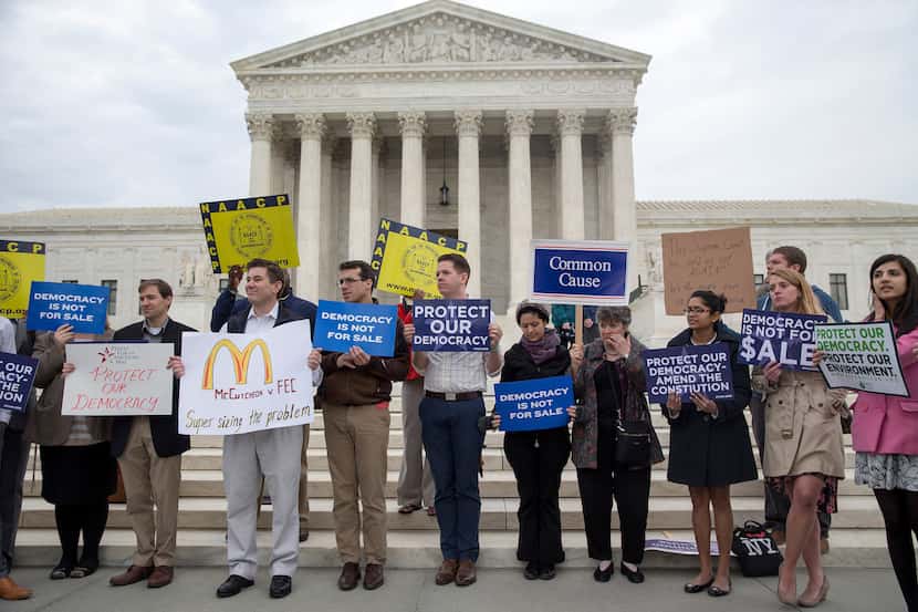 Protesters rally outside the Supreme Court in Washington, April 2, 2014. The Supreme Court...