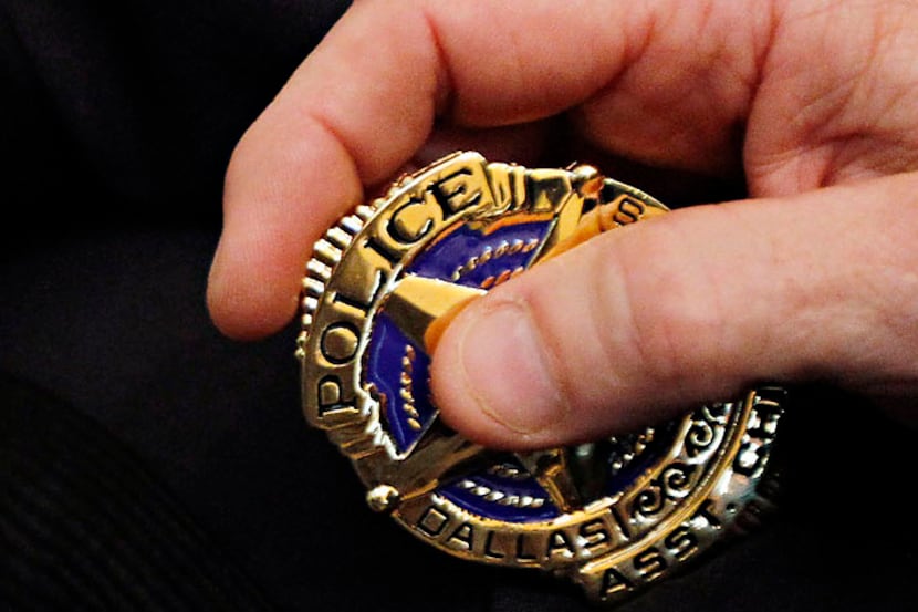 Tom Lawrence holds his new Dallas police badge during July 2010 ceremony announcing his...