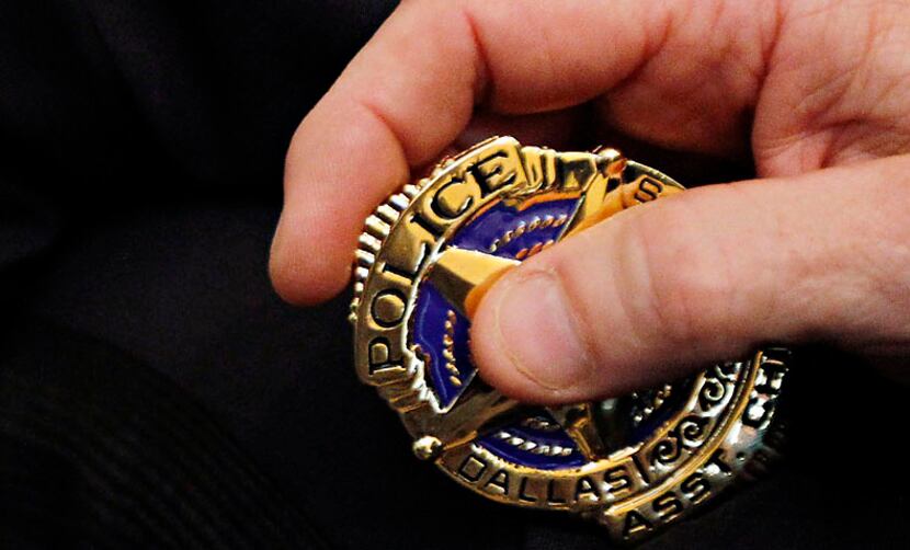 Tom Lawrence holds his new Dallas police badge during July 2010 ceremony announcing his...