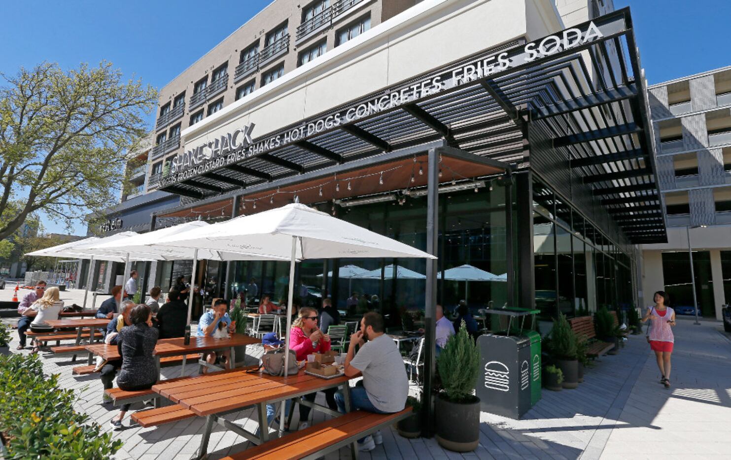 Diners eat lunch in the patio area at Shake Shack that opens its store in the mixed-use...