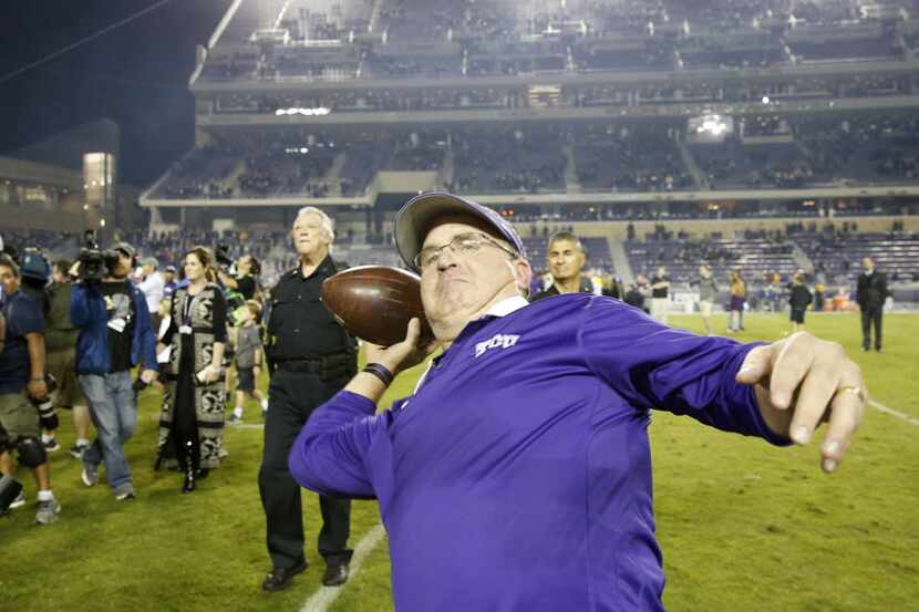 TCU Horned Frogs head coach Gary Patterson heaves a football into the stands after defeating...