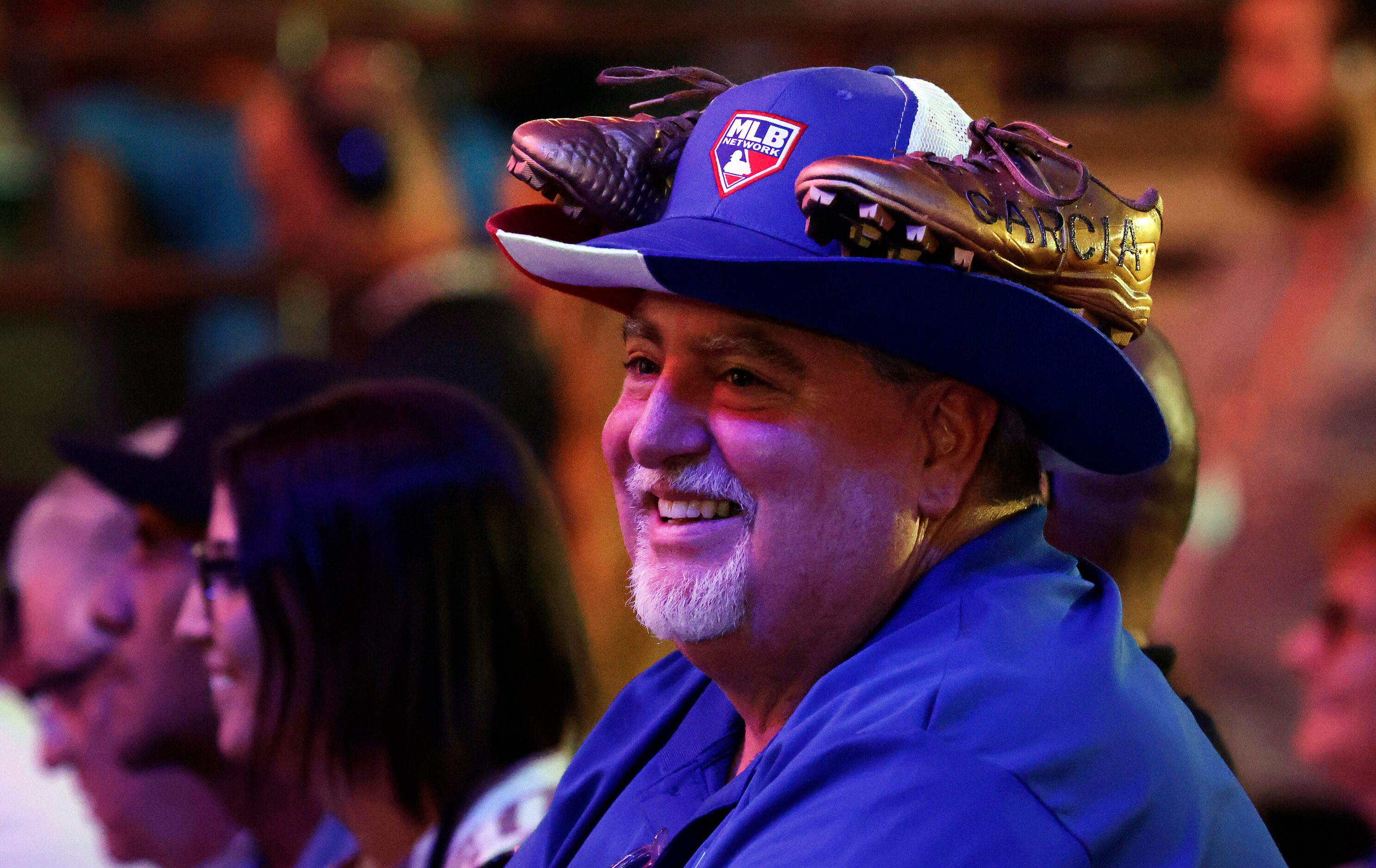 Texas Rangers session ticket holder Jeff Bates dons a gold pair of Adolis Garcia shoes on...