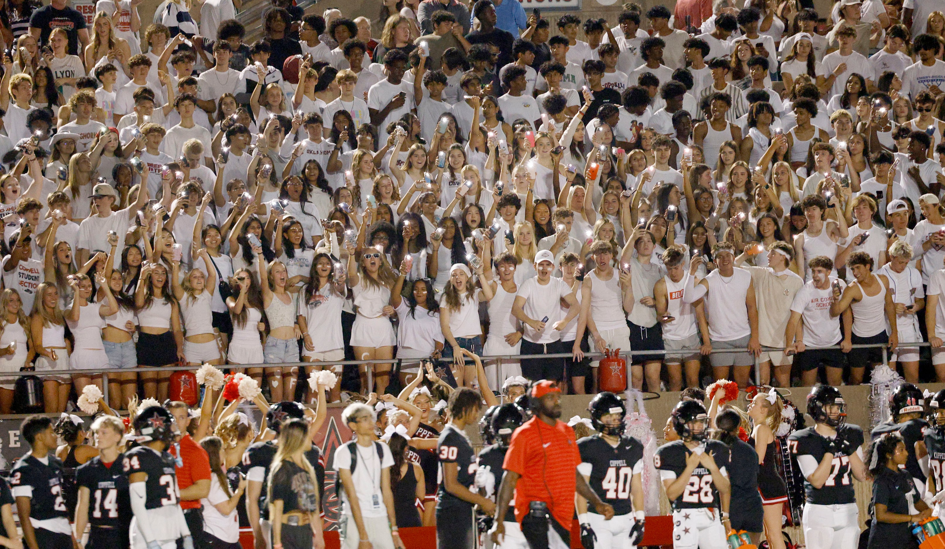 Coppell’s fans cheer in the first half of a high school football game against Hebron,...