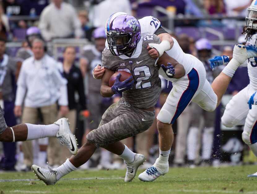 Nov 14, 2015; Fort Worth, TX, USA; TCU Horned Frogs running back Aaron Green (22) is brought...
