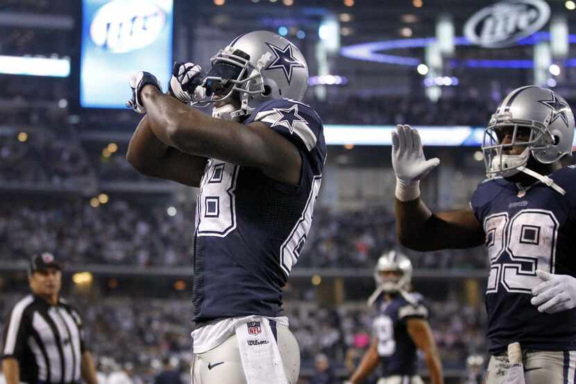 Dallas Cowboys wide receiver Dez Bryant (88) gives the X out sign after catching a third...