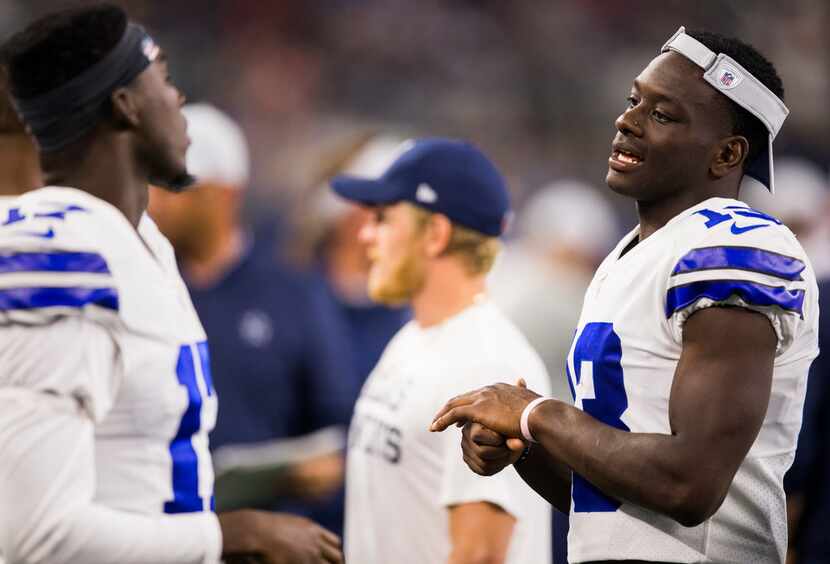 Dallas Cowboys wide receiver Michael Gallup (13) talks to wide receiver Allen Hurns (17) on...