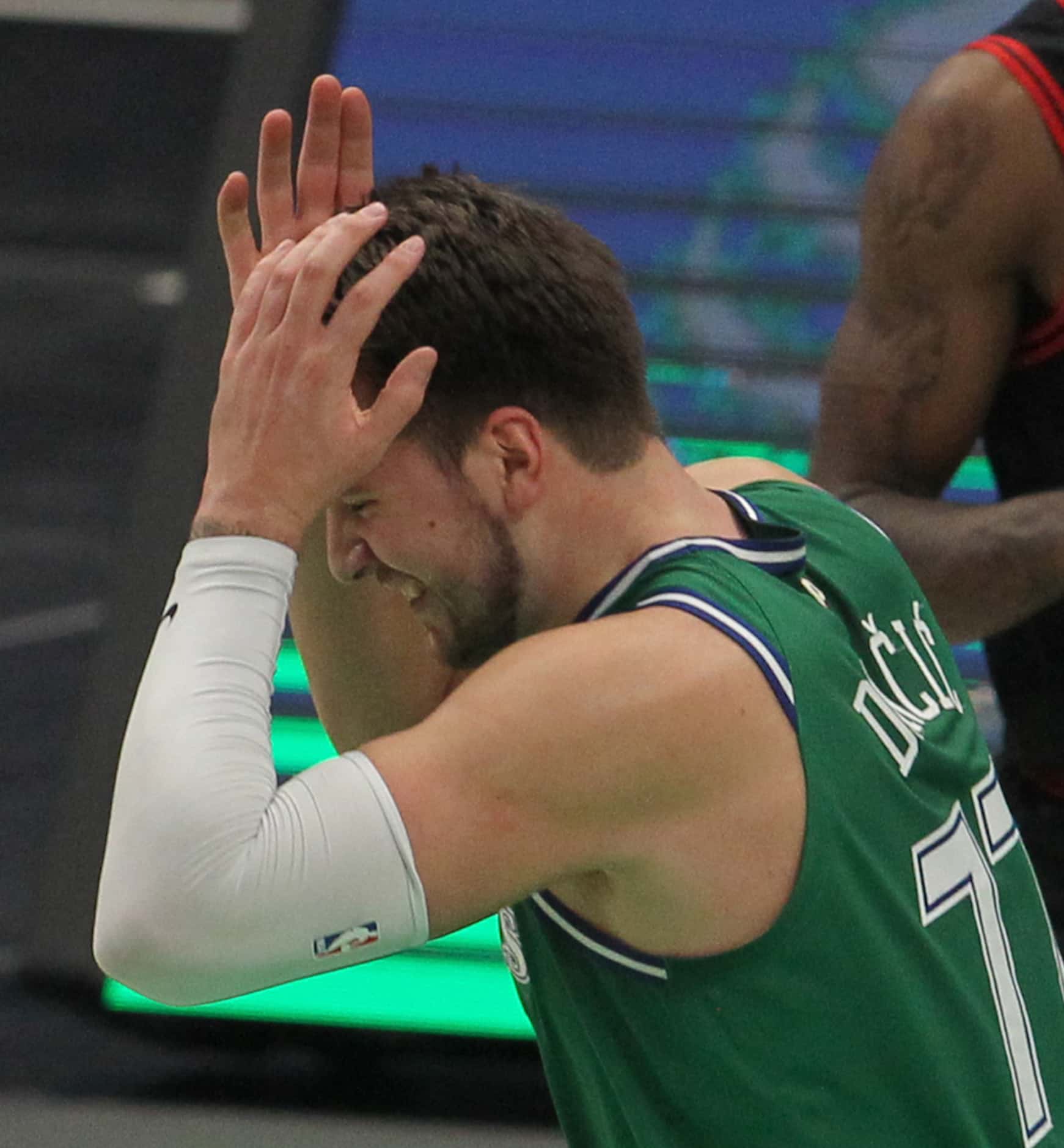 Dallas Mavericks point guard Luka Doncic (77) reacts in frustration after missing back to...