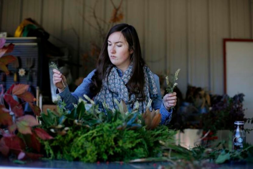 
Andi Jamison of Bows and Arrows floral studio in Old East Dallas builds wreath using the...