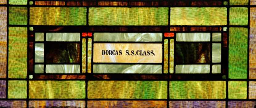 A dedication to a Sunday School class of years past is etched into original  stained glass...