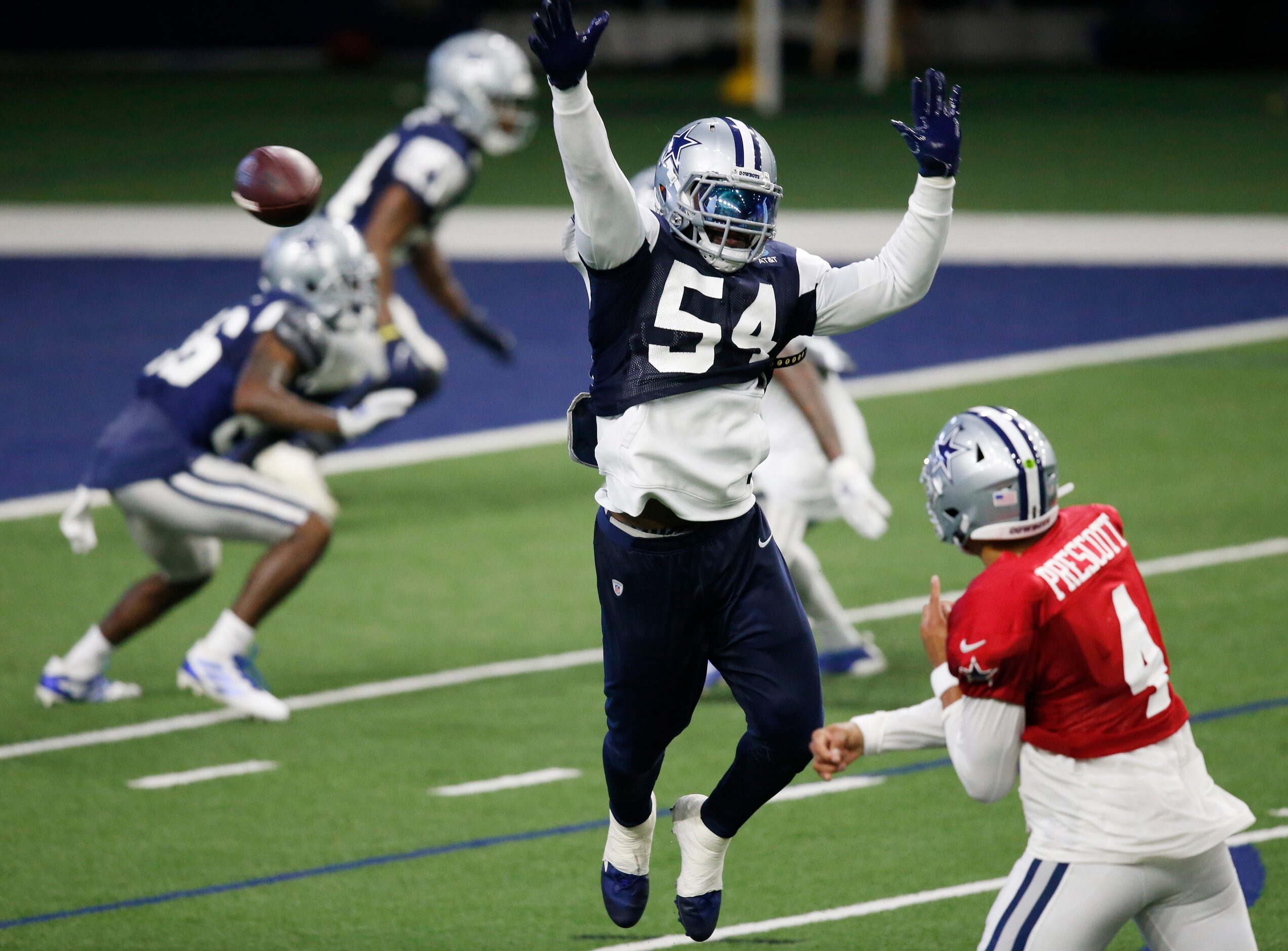 Dallas Cowboys linebacker Jaylon Smith (54) leaps as Dallas Cowboys quarterback Dak Prescott...