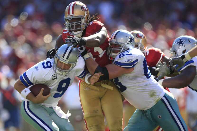 Dallas Cowboys quarterback Tony Romo is sacked by San Francisco 49ers DL Ray McDonald (91)...