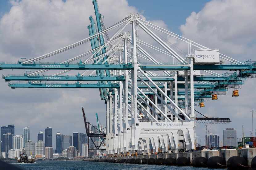 Large cranes wait to unload container ships at PortMiami.
