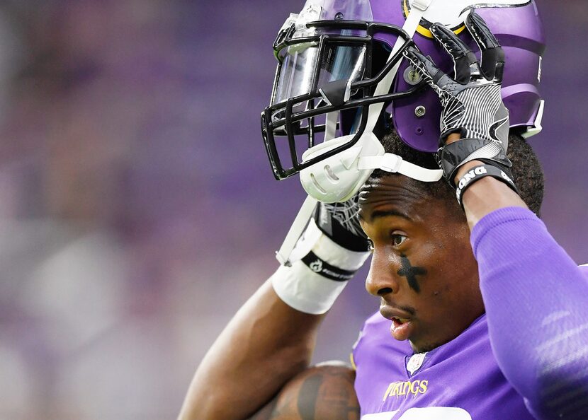 MINNEAPOLIS, MN - AUGUST 24: George Iloka #28 of the Minnesota Vikings puts on his helmet...