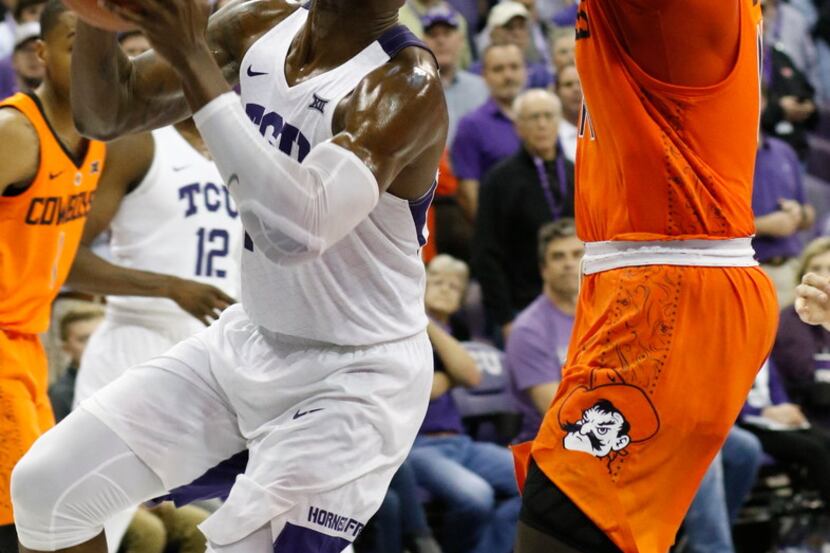 TCU forward JD Miller (15) puts up the winning shot against Oklahoma State during an NCAA...